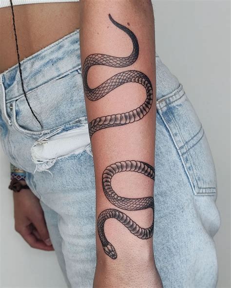 snake tattoo arm wrap meaning.